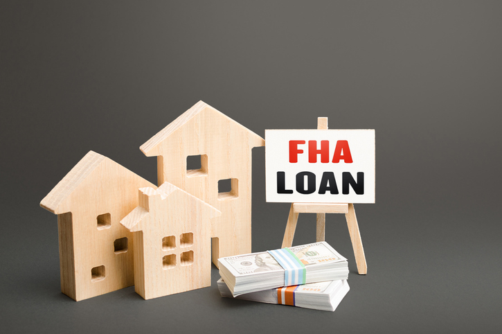 Residential buildings and easel with FHA loan. Mortgage insured by Federal Housing Administration Loan. An affordable financial instrument for borrowers with a low credit score. High risk of default